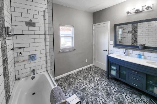 a bathroom with a tub and a sink at Modern Art House in Midtown, Pet Friendly in Phoenix