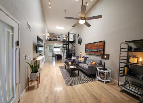 a living room with a couch and a ceiling fan at Modern Art House in Midtown, Pet Friendly in Phoenix