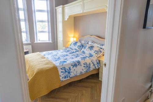a small bedroom with a bed and a mirror at Port Lush in Portrush