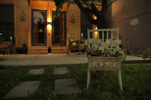 a table with flowers on it in front of a house at Dream House in Yerevan