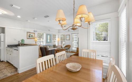 a kitchen and dining room with a table and chairs at Bimini by Oversee 30A in Carillon Beach