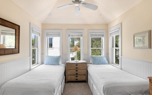 two beds in a room with windows at Bimini by Oversee 30A in Carillon Beach