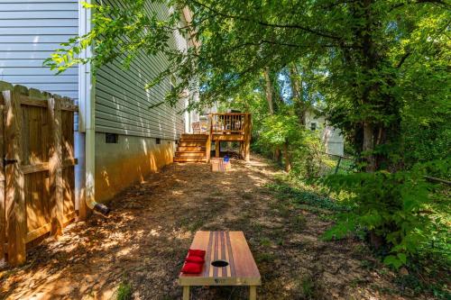 a wooden bench sitting next to a building at Charming 5bd - BBQ - Deck- 4mins Duke University in Durham