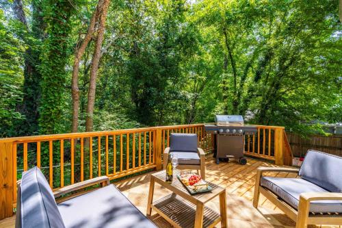 a deck with chairs and a grill with trees at Charming 5bd - BBQ - Deck- 4mins Duke University in Durham