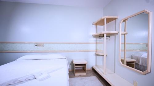 Ένα ή περισσότερα κρεβάτια σε δωμάτιο στο Hotel Center