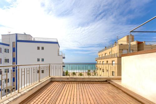a balcony with a view of the ocean at Pool&Beach Apartment Calafell by VM Group in Calafell
