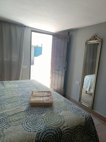 a suitcase sitting on a bed with a mirror at La Rueda, campo y playa en el Medano in El Médano
