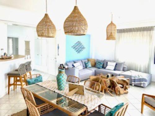 a living room with a couch and a table at My Greek Oasis in Loutraki