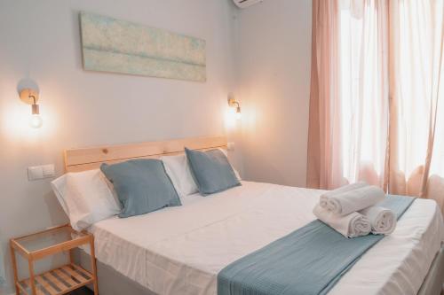 a bedroom with a bed with towels on it at CH Barco in Madrid