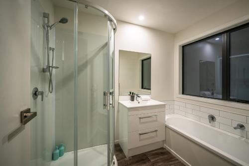 a bathroom with a glass shower and a sink at Nova Heights in Lake Tekapo