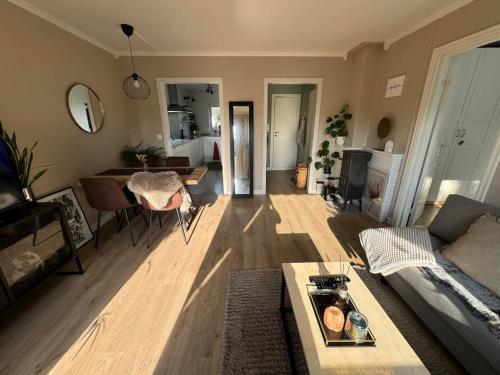 a living room with a couch and a table at Koselig leilighet på Østensjø med stor uteplass in Oslo