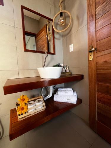 a bathroom with a sink and a mirror at Pousada Recanto do Luar in Serra de São Bento
