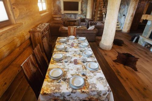 a long table with plates on it in a room at Galicyjska Chata in Kwiatonowice