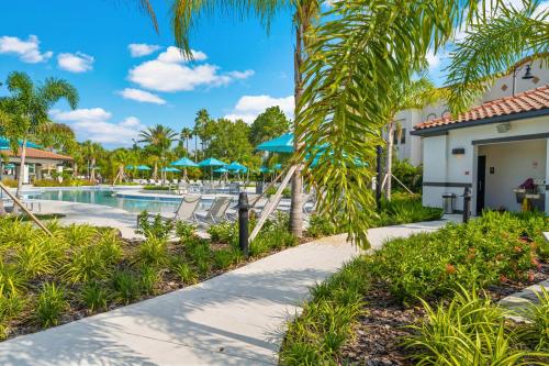a resort pool with chairs and umbrellas at Seaescape in Orlando