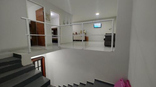 a room with a staircase and a living room at Apto confortável p9 pessoas Níteroi Volta Redonda in Volta Redonda