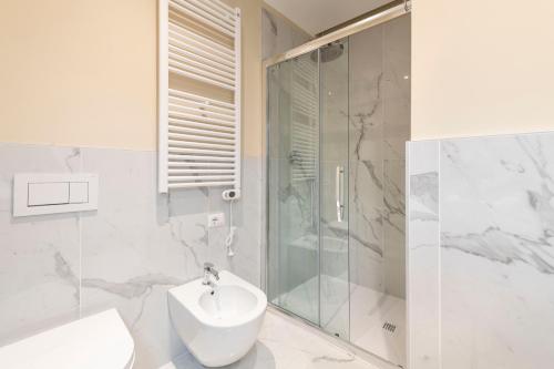 a bathroom with a shower and a toilet and a sink at Heart Milan Apartments San Sepolcro Duomo in Milan