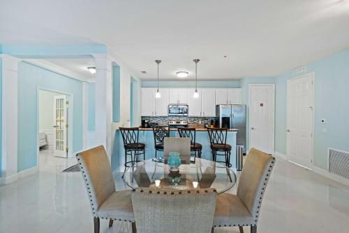 a dining room and kitchen with a glass table and chairs at Seaescape in Orlando
