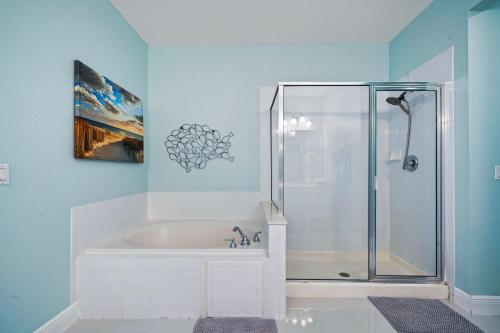 a bathroom with a shower and a bath tub at Seaescape in Orlando