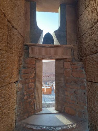 an archway in a stone building with a window at CASA DIDYMA in San Giovanni Gemini