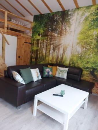 a living room with a couch and a coffee table at Pod Pługiem in Swornegacie 
