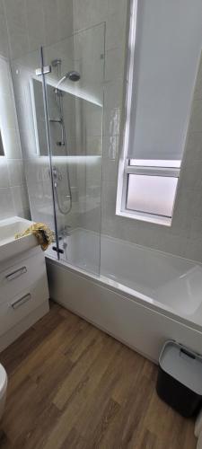 a bathroom with a shower and a toilet and a sink at Port Lush in Portrush