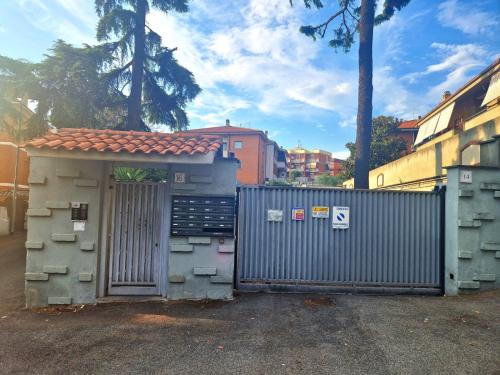 a gate in front of a building with a fence at Roma Centro Apartment Tor Vergata in Tor Vergata