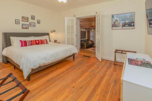 a bedroom with a bed and a wooden floor at Dreamcatcher B&B in Taos