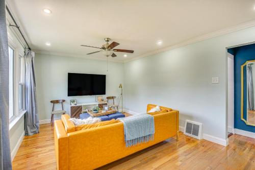 a living room with a couch and a flat screen tv at St Louis Home Less Than 1 Mi to Forest Park! in Benton