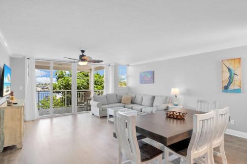 a living room with a table and a couch at Eleuthera - 2x2 Fully Updated Old Town Waterfront Corner Condo in Key West