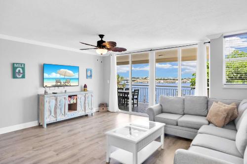 a living room with a couch and a table at Eleuthera - 2x2 Fully Updated Old Town Waterfront Corner Condo in Key West
