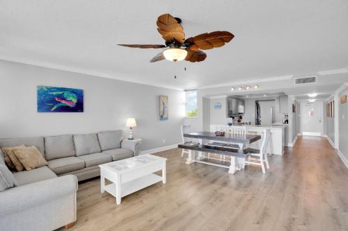 a living room with a couch and a ceiling fan at Eleuthera - 2x2 Fully Updated Old Town Waterfront Corner Condo in Key West