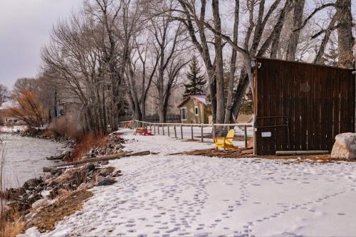 a snow covered yard with footprints in the snow at Chinook Winds Lodge in Dubois