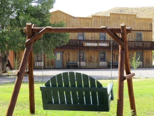 a swing in a yard with a building in the background at Chinook Winds Lodge in Dubois