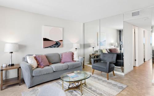 a living room with a couch and a chair at Ocean Breezes by Oversee 30A in Carillon Beach