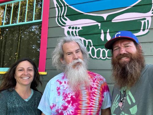two men and a woman standing in front of a building at Grateful Dreams Lodging in Arcata