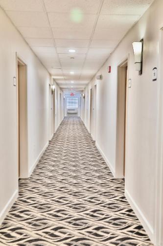 an empty hallway of a hospital with a carpeted corridor at Baymont by Wyndham Tucson Airport in Tucson