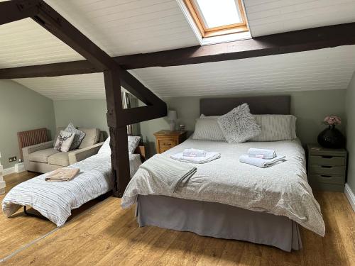 a bedroom with a large bed and a window at The Hurst Coach House in Stafford