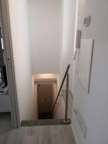 a stairway with a stair railing in a white room at Casa Vacanze Riflessi sul mare in Calasetta