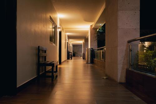 a hallway of a building with wooden floors and lights at Luxury Hotel Inn in Peñita de Jaltemba