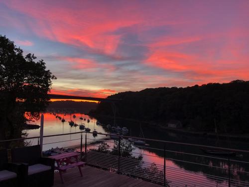 a sunset over a river with boats in the water at Maison vue Rivière du Bono 8 personnes in Le Bono