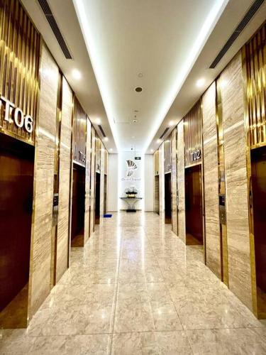 a hallway of a building with doors and a hallwayngth at More Than Home - Căn hộ ấm áp, gần gũi, hiện đại! in Hạ Lý