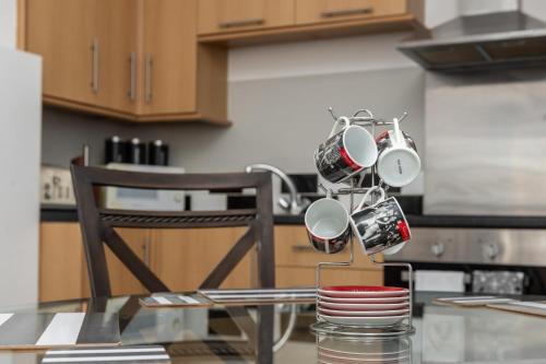 a group of pots and pans on a table in a kitchen at Sunrise Central in Bexhill