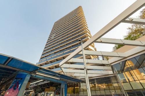 a tall building with a staircase in front of a building at Yume On Paulista in São Paulo