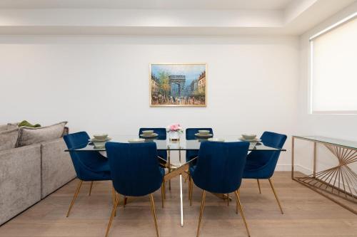 a dining room with a table and blue chairs at Stylish Apartments in Glendale with Free Parking in Glendale