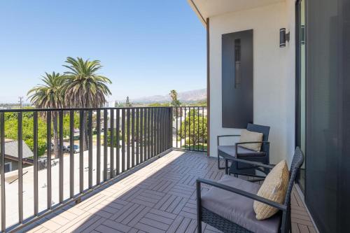 a balcony with a couch and chairs on a balcony at Stylish Apartments in Glendale with Free Parking in Glendale
