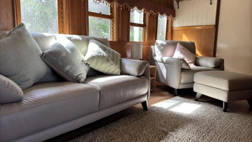 a living room with a couch and a chair at Heaven in the Hills Retreat in Maleny