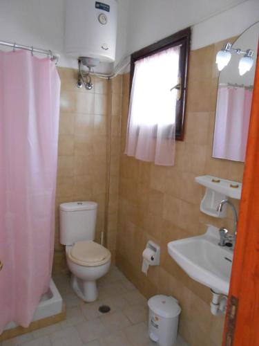 a small bathroom with a toilet and a sink at ANAMAMA -SOCRATES studios in Acharavi