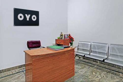 an office with a desk with a sign on the wall at Hotel O Home Elite Stay Near Shri Shri Shiridi Sai Mandir in Bhubaneshwar