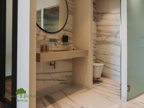 a bathroom with a sink and a mirror at Olive Nature Hotel & SPA - Quinta Valle de Passos in Valpaços