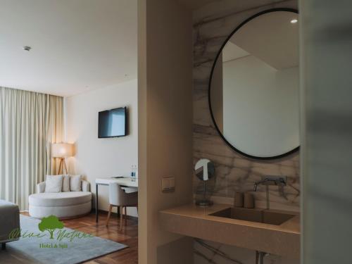a bathroom with a sink and a mirror at Olive Nature Hotel & SPA - Quinta Valle de Passos in Valpaços